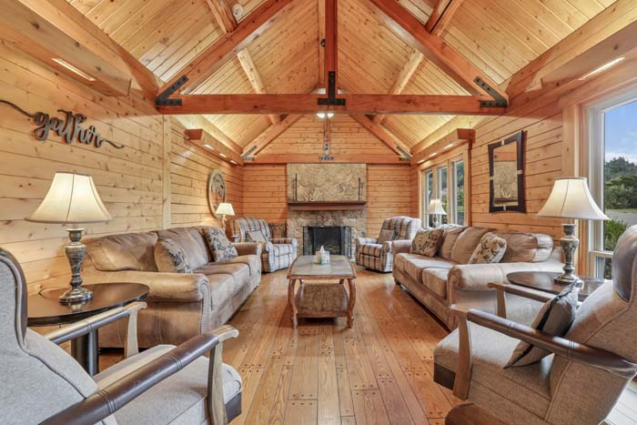 Cabin at the Crossroads Rustic bedroom with large windows.