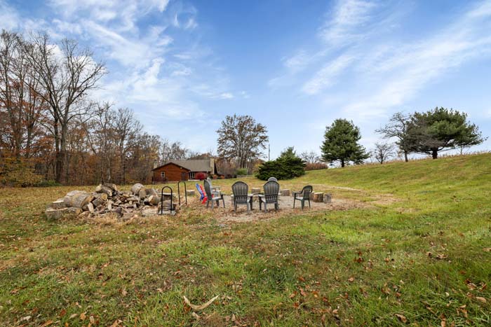 Cabin at the Crossroads Outdoor fire pit with seating.